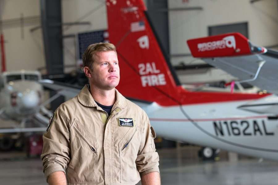 Tim Sheehy, in uniform at an airplane hangar.